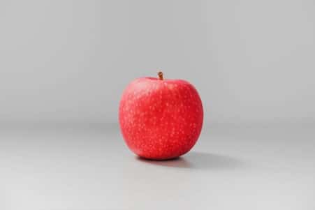 Red apple on a grey background